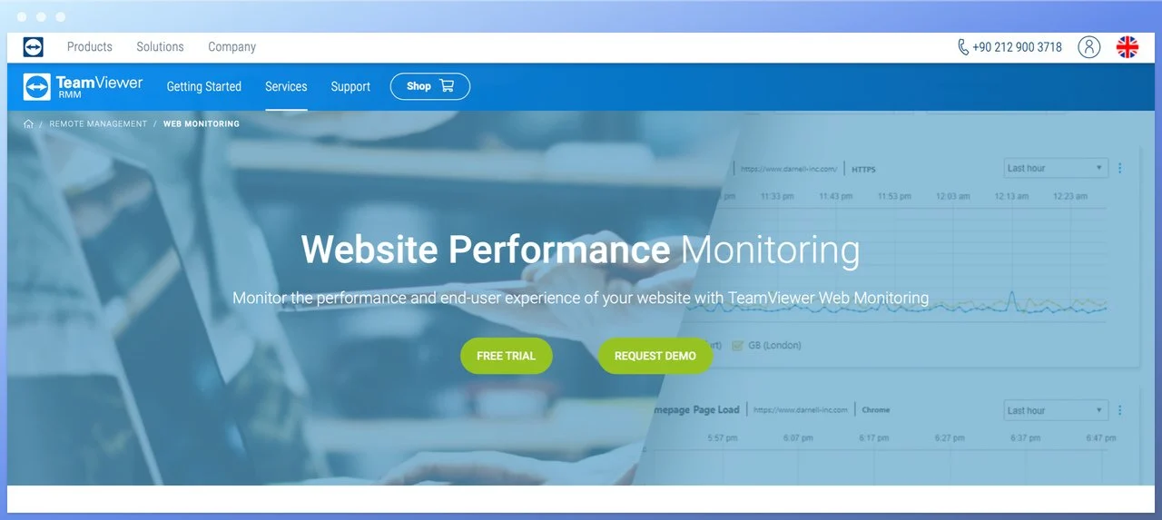 Teamviewer web monitoring homepage screenshot with website performance monitoring headline in the center and free trial and request demo buttons below on a laptop and hands background