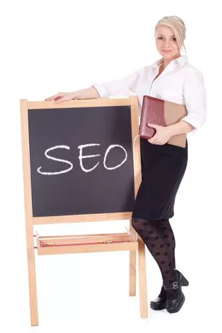 Woman Standing Next to Chalkboard